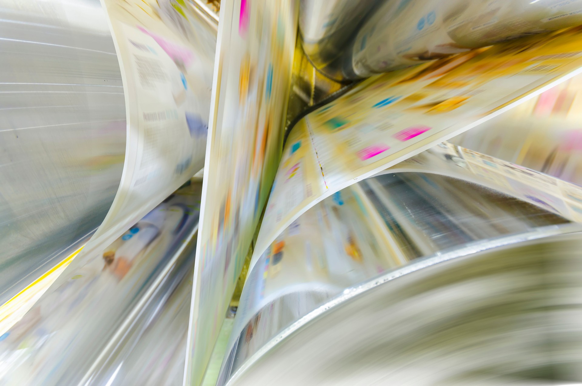Large webset offset printing press running long roll of paper